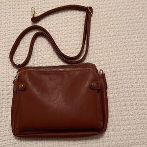 Vegan leather purse brown with strap multiple zipper compartments and pockets.